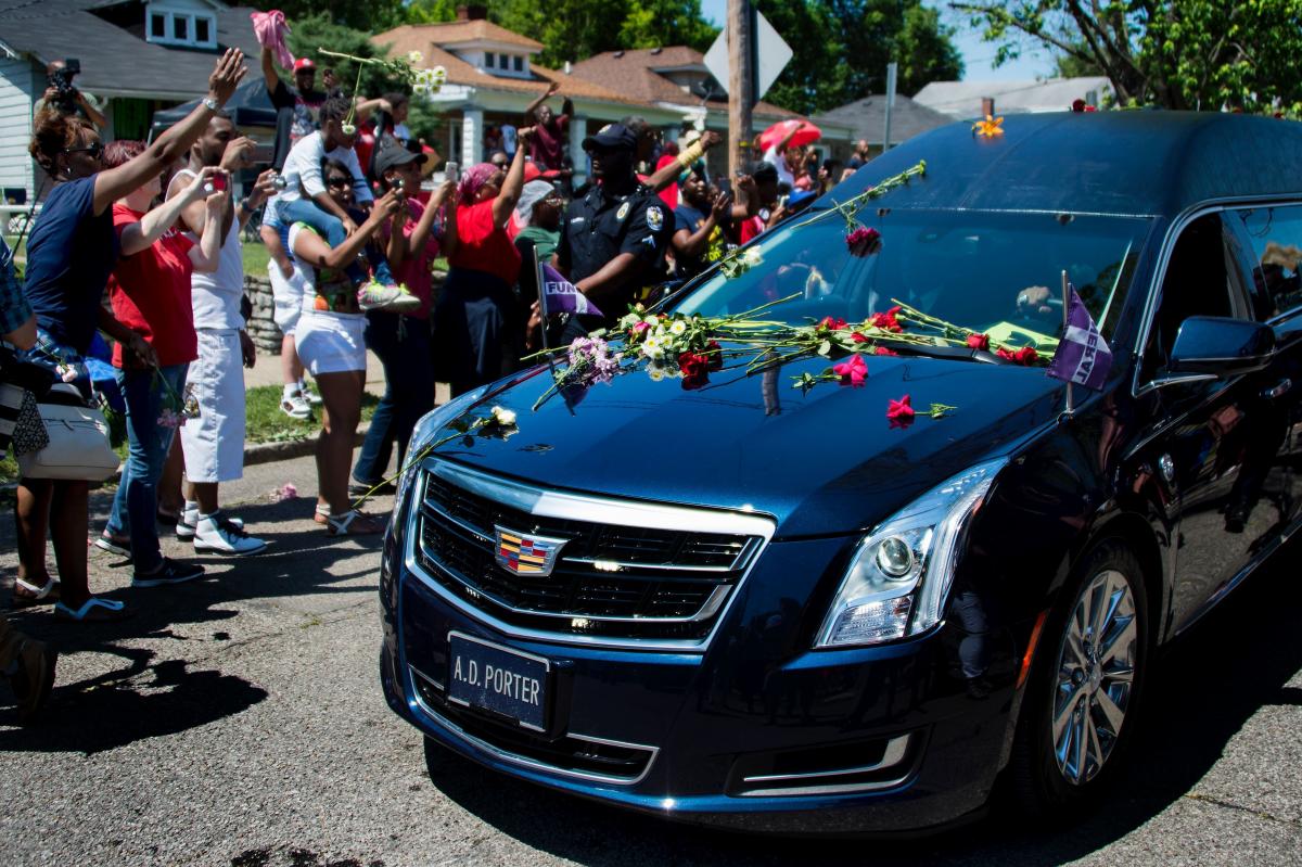 Fans And Mourners Throw Flowers On The Hearse That Carries The Casket