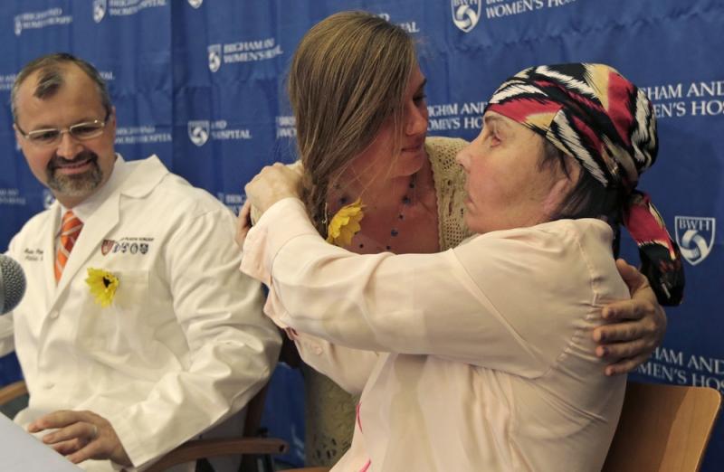 Carmen Blandin Tarleton of Thetford, Vermont, right, is embraced by Marinda Righter, daughter of face donor Cheryl Denelli-Righter, at Brigham and Women's Hospital in Boston, Mass., on Wednesday. Carmen Blandin Tarleton of Thetford, Vermont, right, is embraced by Marinda Righter, daughter of face donor Cheryl Denelli-Righter, at Brigham and Women's Hospital in Boston, Mass., on Wednesday.