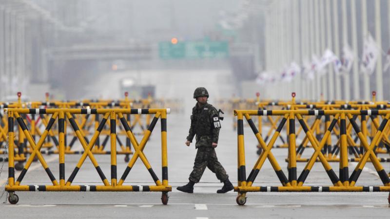 A South Korean soldier patrols as vehicles returning from the jointly run Kaesong industrial complex in North Korea arrive at a checkpoint in Paju, north of Seoul, on April 6. A South Korean soldier patrols as vehicles returning from the jointly run Kaesong industrial complex in North Korea arrive at a checkpoint in Paju, north of Seoul, on April 6.