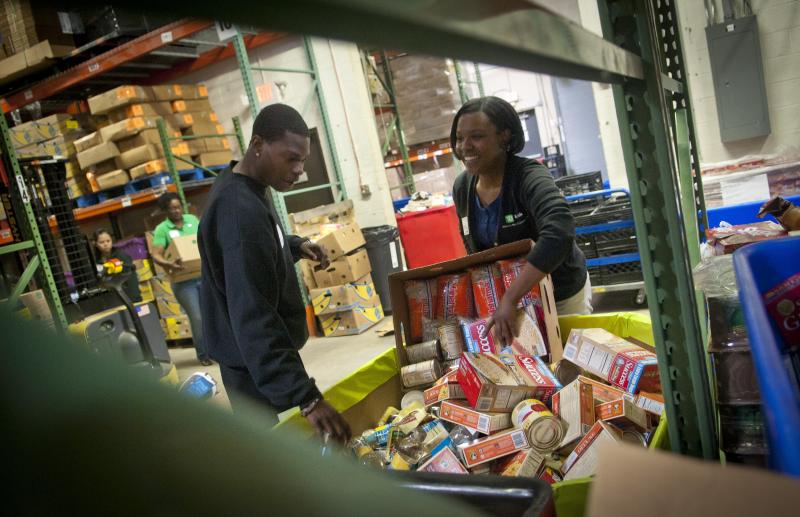 TD Bank volunteers sort donated food into barrels at the Manna Food Center in Gaithersburg in Montgomery County, Md. Poverty in the county just outside Washington, D.C., has grown by two-thirds since 2007. TD Bank volunteers sort donated food into barrels at the Manna Food Center in Gaithersburg in Montgomery County, Md. Poverty in the county just outside Washington, D.C., has grown by two-thirds since 2007.