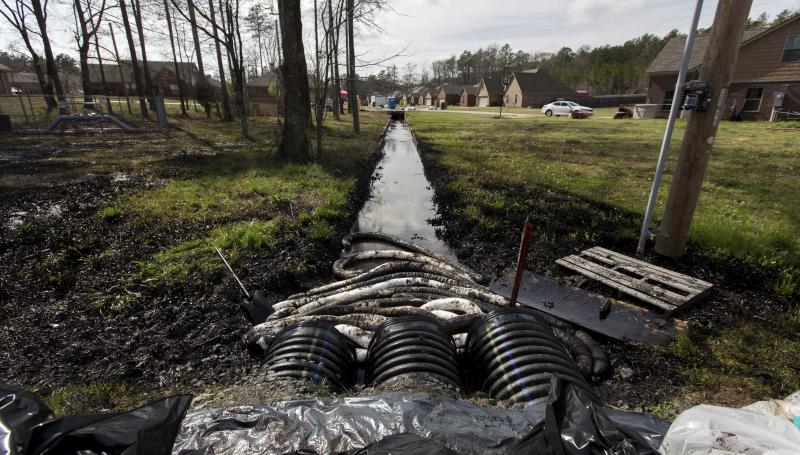 Spilled crude oil is seen in a drainage ditch near evacuated homes near Starlite Road in Mayflower, Ark., on March 31. An Exxon Mobil pipeline carrying Canadian crude oil was shut off after it ruptured March 29, causing an evacuation of 22 homes. Spilled crude oil is seen in a drainage ditch near evacuated homes near Starlite Road in Mayflower, Ark., on March 31. An Exxon Mobil pipeline carrying Canadian crude oil was shut off after it ruptured March 29, causing an evacuation of 22 homes.