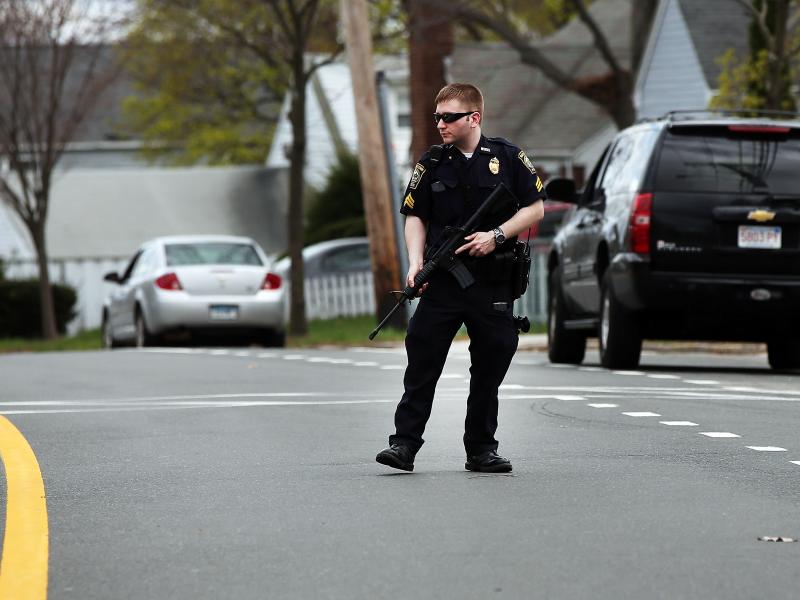 A police officer stands on the street in Watertown, Mass., during the search for bombing suspect Dzhokhar Tsarnaev on Friday. A police officer stands on the street in Watertown, Mass., during the search for bombing suspect Dzhokhar Tsarnaev on Friday.