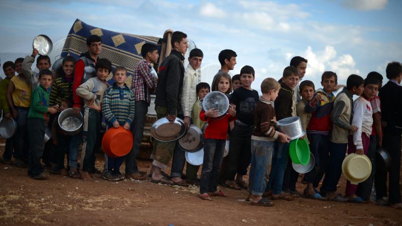 Syrian youths line up for food distribution in the Maiber al-Salam refugee camp in northern Syria, near the border with Turkey. The U.S. government has provided more than $1.5 billion in aid to Syrians since the uprising began in 2011. Syrian youths line up for food distribution in the Maiber al-Salam refugee camp in northern Syria, near the border with Turkey. The U.S. government has provided more than $1.5 billion in aid to Syrians since the uprising began in 2011.