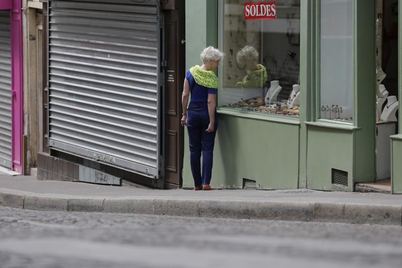 A woman walks amid both open and closed shops during a Sunday morning stroll at the Butte Montmartre in Paris, in July. Under France's Byzantine rules on Sunday trading, shops at the top of the hill are in a designated tourist area and so can open, but th A woman walks amid both open and closed shops during a Sunday morning stroll at the Butte Montmartre in Paris, in July. Under France's Byzantine rules on Sunday trading, shops at the top of the hill are in a designated tourist area and so can open, but th