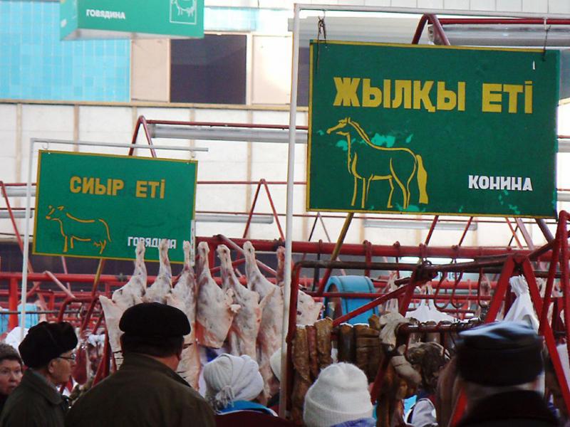 Signs advertise the type of meat sold in each section of the Green Market in Almaty, Kazakhstan. Signs advertise the type of meat sold in each section of the Green Market in Almaty, Kazakhstan.