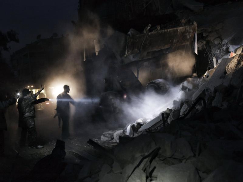 Syrians look for survivors amid the rubble of a building targeted by a missile in the al-Mashhad neighborhood of Aleppo on Jan. 7. Syrians look for survivors amid the rubble of a building targeted by a missile in the al-Mashhad neighborhood of Aleppo on Jan. 7.