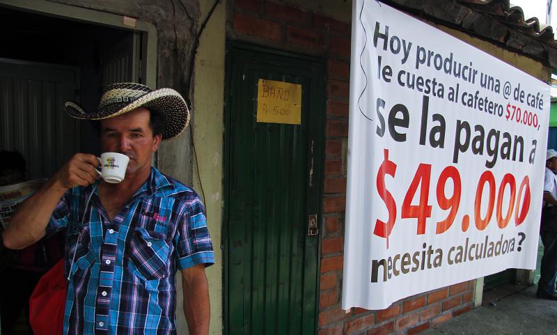 A Colombian farmer sips cofee during a national coffee producers' strike Feb. 25 in Colombia. Thousands of coffee farmers rallied and marched throughout Colombia in protest the economic difficulties of the sector. A Colombian farmer sips cofee during a national coffee producers' strike Feb. 25 in Colombia. Thousands of coffee farmers rallied and marched throughout Colombia in protest the economic difficulties of the sector.