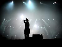 A teen sings on stage. A teen sings on stage.
