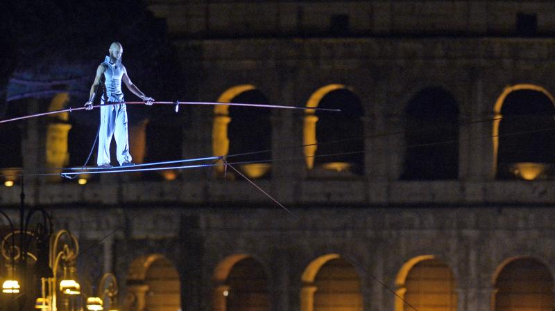 Tightrope walker Andrea Loreni performs in front of the Coliseum in Rome on Saturday. Rome's new mayor is on a crusade to make the ancient monuments more pedestrian friendly, and the city held an all-night street party as it permanently blocked off part o Tightrope walker Andrea Loreni performs in front of the Coliseum in Rome on Saturday. Rome's new mayor is on a crusade to make the ancient monuments more pedestrian friendly, and the city held an all-night street party as it permanently blocked off part o
