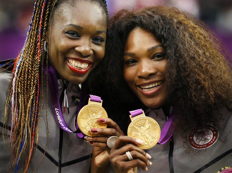 Serena (right) and Venus Williams pose with their gold medals during the London 2012 Olympic Games. Serena (right) and Venus Williams pose with their gold medals during the London 2012 Olympic Games.