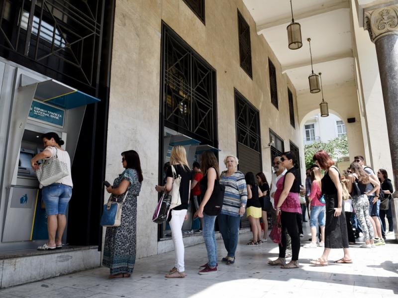 People stand in a line to use the ATMs of a bank in the northern Greek city of Thessaloniki on Saturday after the country's prime minister announced a snap referendum on an international bailout â pushing Athens toward a Tuesday deadline for a plan t People stand in a line to use the ATMs of a bank in the northern Greek city of Thessaloniki on Saturday after the country's prime minister announced a snap referendum on an international bailout â pushing Athens toward a Tuesday deadline for a plan t