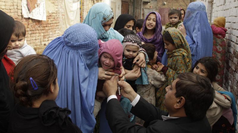 A health worker injects a vaccine to prevent polio and measles in Lahore, Pakistan. A health worker injects a vaccine to prevent polio and measles in Lahore, Pakistan.