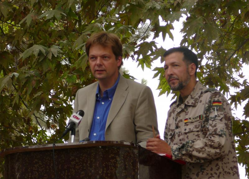 German official Philipp Ackermann gives a speech with military translator Mohamed Oda in 2006, while heading the Provincial Reconstruction Team. German official Philipp Ackermann gives a speech with military translator Mohamed Oda in 2006, while heading the Provincial Reconstruction Team.