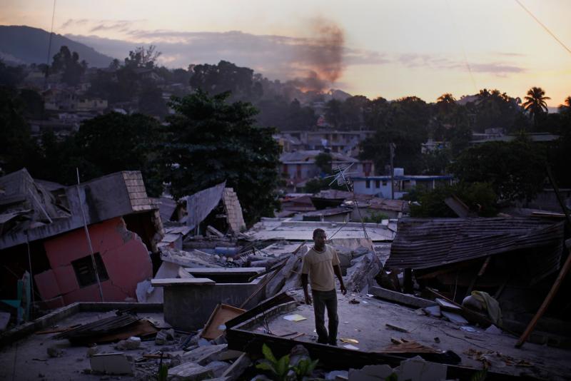 After the quake of 2010, a man stands on a rooftop yelling for any sign of his missing relatives in a Port-au-Prince neighborhood. After the quake of 2010, a man stands on a rooftop yelling for any sign of his missing relatives in a Port-au-Prince neighborhood.