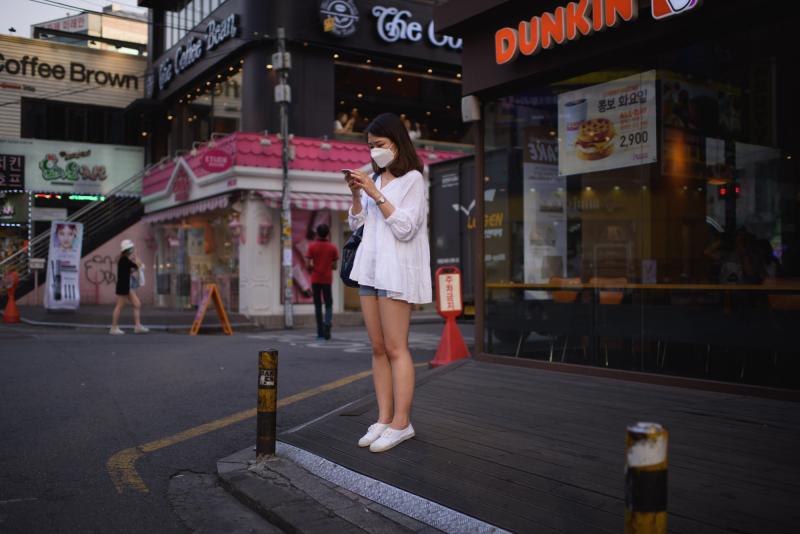 A woman on a street in Seoul checks her cellphone. The government is ramping up efforts to control an outbreak of the Middle East respiratory syndrome by monitoring the smartphones of those under quarantine. A woman on a street in Seoul checks her cellphone. The government is ramping up efforts to control an outbreak of the Middle East respiratory syndrome by monitoring the smartphones of those under quarantine.