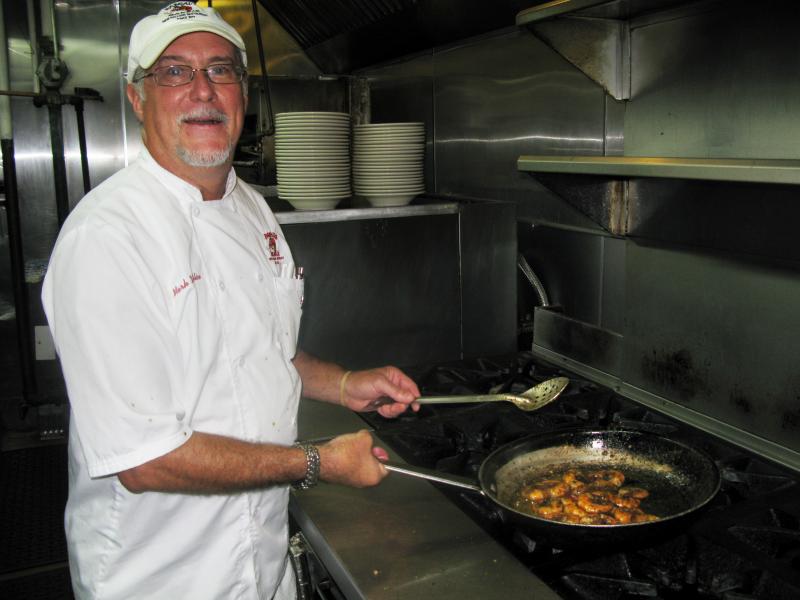 Co-owner and chef Mark DeFelice cooks up an order of barbecue shrimp at Pascal's Manale restaurant in New Orleans. Co-owner and chef Mark DeFelice cooks up an order of barbecue shrimp at Pascal's Manale restaurant in New Orleans.