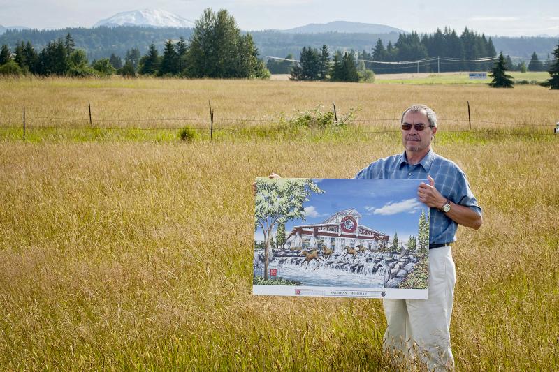 Tribal Chairman Bill Iyall stands on Cowlitz Tribe reservation land with a rendering of the casino the tribe hopes to build on the site near La Center, Washington, just north of Portland, Ore. Tribal Chairman Bill Iyall stands on Cowlitz Tribe reservation land with a rendering of the casino the tribe hopes to build on the site near La Center, Washington, just north of Portland, Ore.