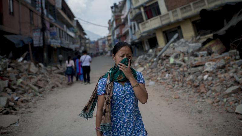A woman in Kathmandu walks past rubble following several massive earthquakes in Nepal. Officials say at least 76 people died in Tuesday's magnitude-7.3 quake. A woman in Kathmandu walks past rubble following several massive earthquakes in Nepal. Officials say at least 76 people died in Tuesday's magnitude-7.3 quake.
