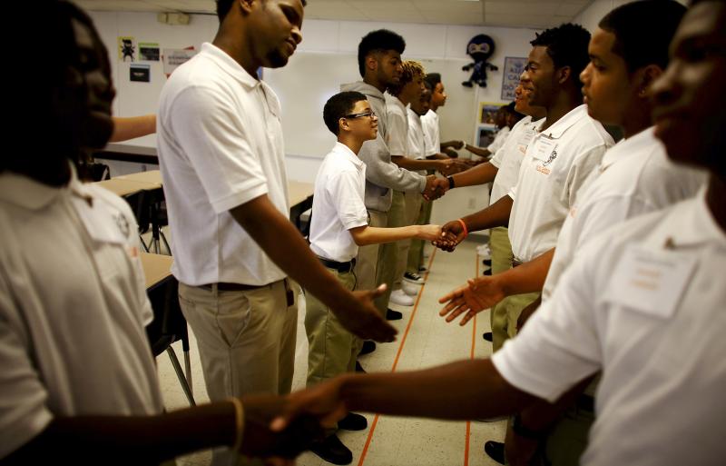 Ninth graders at George Washington Carver Collegiate Academy learn to shake hands and greet each other during the first day of school in New Orleans. Ninth graders at George Washington Carver Collegiate Academy learn to shake hands and greet each other during the first day of school in New Orleans.
