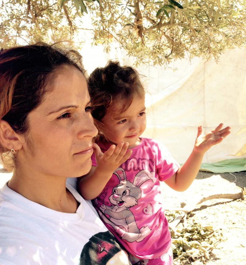 Selma Halik, holding her 2-year-old daughter Amara at a refugee camp on the Greek island of Lesbos, says much of her family was wiped out by ISIS. She doesn't want her daughter to see the things she's seen. Selma Halik, holding her 2-year-old daughter Amara at a refugee camp on the Greek island of Lesbos, says much of her family was wiped out by ISIS. She doesn't want her daughter to see the things she's seen.