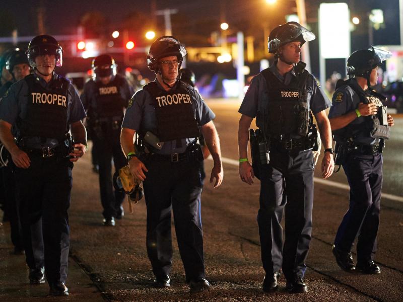 Police patrol Ferguson, Mo., on Monday night after St. Louis County issued a state of emergency. Police patrol Ferguson, Mo., on Monday night after St. Louis County issued a state of emergency.