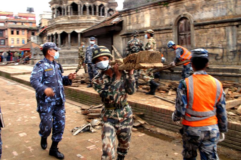 Uniformed police move wooden beams, stack broken bricks and sift through ruined monuments -- some of which date back to the 1600s -- in the city of Patan in the aftermath of Nepal's massive earthquake. Uniformed police move wooden beams, stack broken bricks and sift through ruined monuments -- some of which date back to the 1600s -- in the city of Patan in the aftermath of Nepal's massive earthquake.