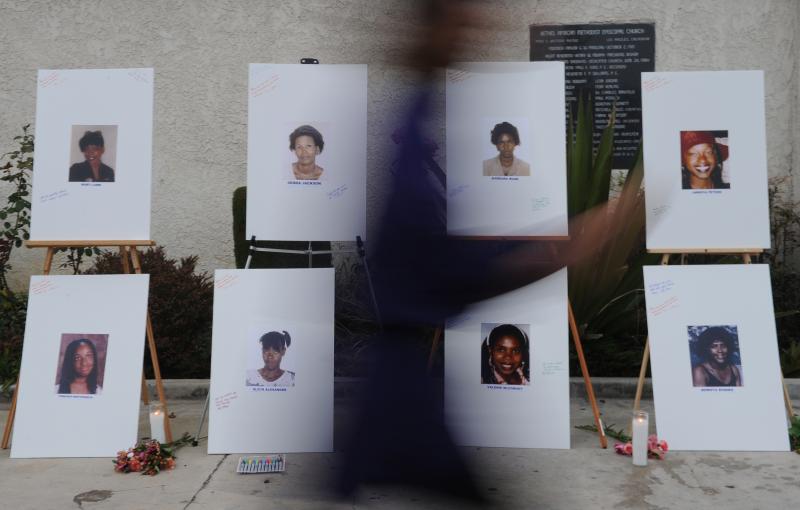 A woman walks past a memorial for some of the victims who are said to have died at the hands of the serial killer dubbed the "Grim Sleeper." A woman walks past a memorial for some of the victims who are said to have died at the hands of the serial killer dubbed the "Grim Sleeper."