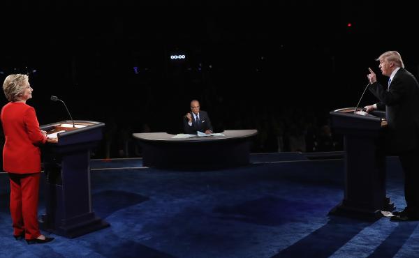Republican presidential nominee Donald Trump speaks as Democratic presidential nominee Hillary Clinton and Moderator Lester Holt listen during the presidential debate at Hofstra University on September 26, 2016 in Hempstead, New York. Republican presidential nominee Donald Trump speaks as Democratic presidential nominee Hillary Clinton and Moderator Lester Holt listen during the presidential debate at Hofstra University on September 26, 2016 in Hempstead, New York.