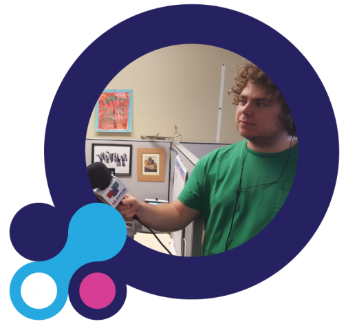 Image of a WFDD intern holding a mic