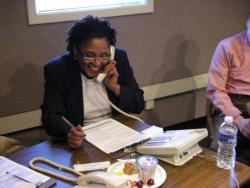 A woman volunteers for WFDD by answering the phone during a pledge drive.