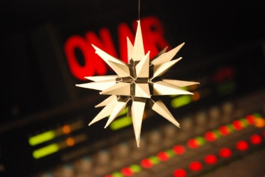 A gold Moravian star in front of a radio control panel.