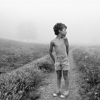 boy stand in narrow dirt road