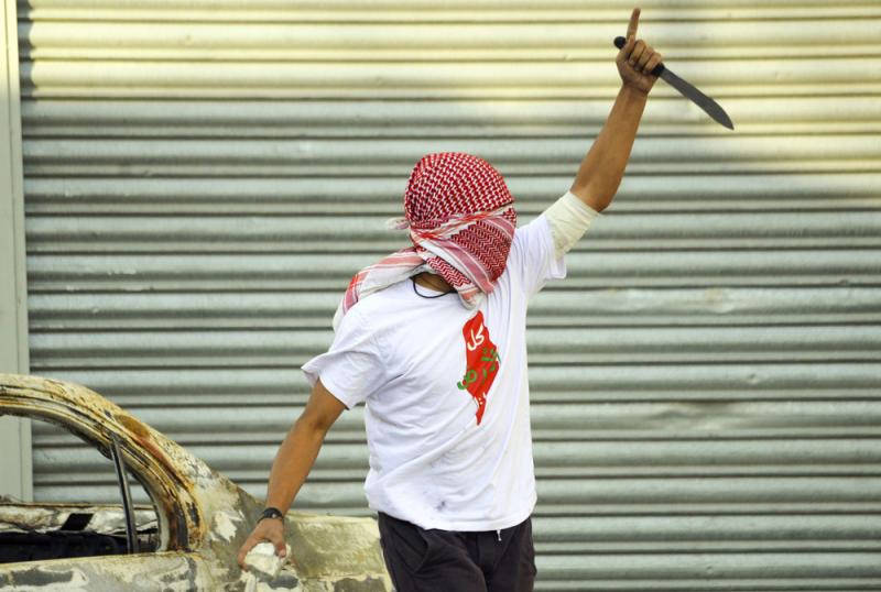 A Palestinian raises a knife during clashes with Israeli police in the Shuafat refugee camp in Jerusalem on Oct. 9. After a series of Palestinian stabbing attacks, some Israeli stores have removed knives from their shelves. A Palestinian raises a knife during clashes with Israeli police in the Shuafat refugee camp in Jerusalem on Oct. 9. After a series of Palestinian stabbing attacks, some Israeli stores have removed knives from their shelves.