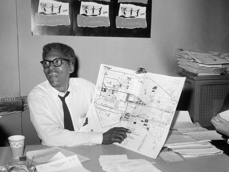 Activist Bayard Rustin points to a map during a press conference four days ahead of the March on Washington in August 1963. Activist Bayard Rustin points to a map during a press conference four days ahead of the March on Washington in August 1963.