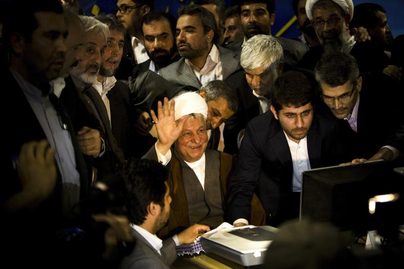 Former Iranian President Ali Akbar Hashemi Rafsanjani (center) waves as he registers his candidacy for the upcoming presidential election at the interior ministry in Tehran, May 11. Rafsanjani has been isolated since massive street protests in 2009 after Former Iranian President Ali Akbar Hashemi Rafsanjani (center) waves as he registers his candidacy for the upcoming presidential election at the interior ministry in Tehran, May 11. Rafsanjani has been isolated since massive street protests in 2009 after