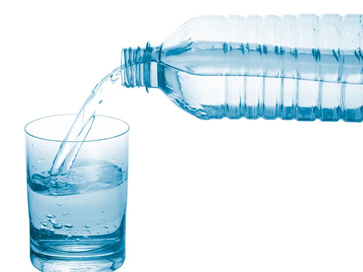 Water pouring from a bottle into a glass. Water pouring from a bottle into a glass.