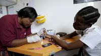 A nurse takes a blood sample from Nkosi Minenhle, 15, in a mobile clinic set up to test students for HIV at Madwaleni High School in KwaZulu Natal, South Africa. A nurse takes a blood sample from Nkosi Minenhle, 15, in a mobile clinic set up to test students for HIV at Madwaleni High School in KwaZulu Natal, South Africa.