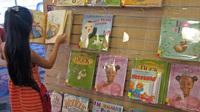 At a San Jose, Calif. library, a young reader browses a shelf of books featuring a variety of main characters: ducks, hens, white kids, black kids. Libraries help drive demand for children's books with nonwhite characters, but book publishers say there ar At a San Jose, Calif. library, a young reader browses a shelf of books featuring a variety of main characters: ducks, hens, white kids, black kids. Libraries help drive demand for children's books with nonwhite characters, but book publishers say there ar