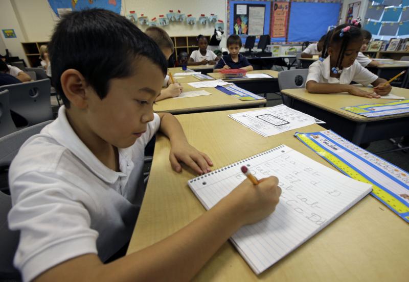 Jaeden Alvarez practices cursive writing at Cleveland K-6 School, Wednesday, Sept. 18, 2013, in Dayton, Ohio. In years gone by, penmanship helped distinguish the literate from the illiterate. But now, in the digital age, people are increasingly communicat