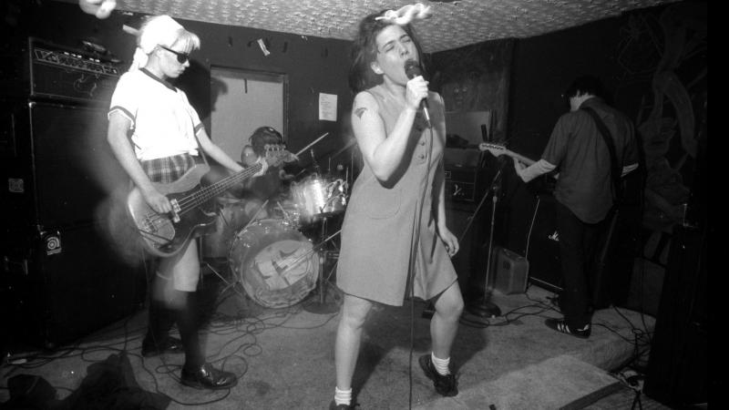 Bikini Kill performs in Washington, D.C., in the 1990s. Bikini Kill performs in Washington, D.C., in the 1990s.