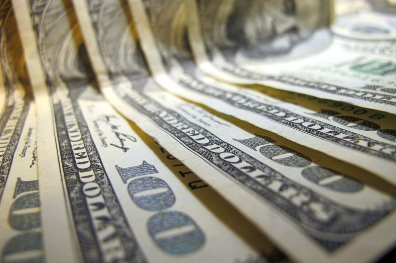 Cash, seen partly out of focus. Cash, seen partly out of focus.