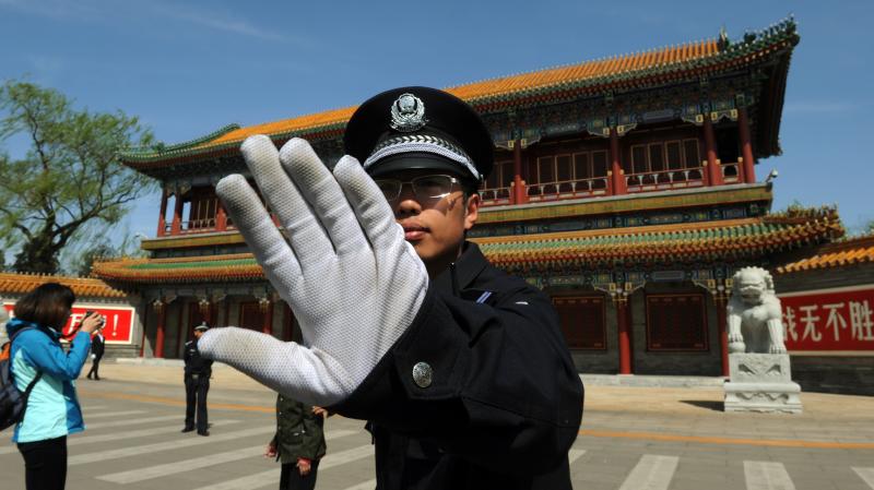 A police officer blocks photos from being taken outside Zhongnanhai, the central headquarters for the Communist Party of China, in Beijing last year. A police officer blocks photos from being taken outside Zhongnanhai, the central headquarters for the Communist Party of China, in Beijing last year.