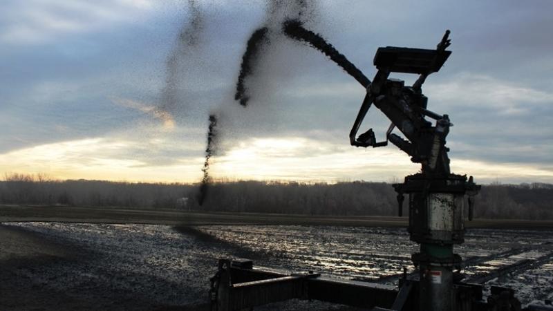 Thick jets of processed sewage arc out 30 to 40 feet from giant moving spreaders at Birmingham Farm in Kansas City, Mo. Thick jets of processed sewage arc out 30 to 40 feet from giant moving spreaders at Birmingham Farm in Kansas City, Mo.