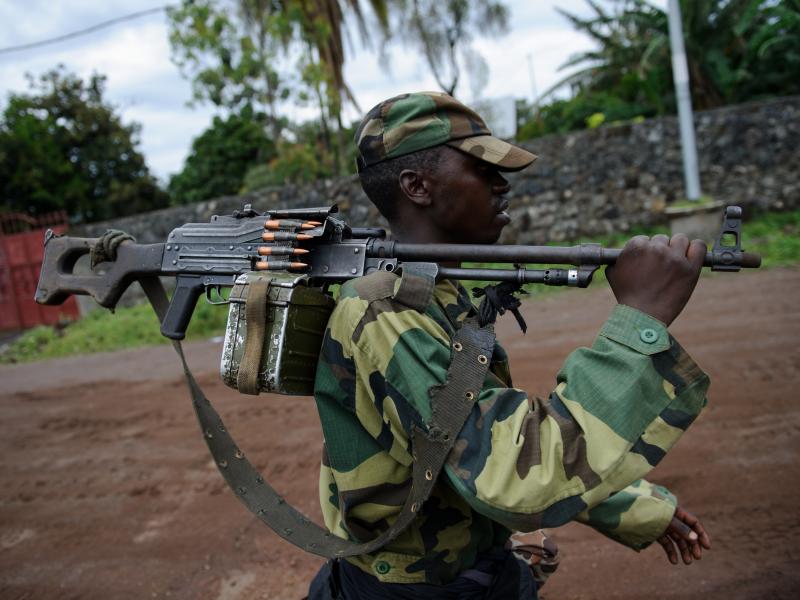 On Nov. 20, an M23 rebel walks on the streets of Goma. The rebels initially claimed control of the town, but retreated 10 days later under international pressure. However, many people think M23 never really left — rather, they just changed into civilian On Nov. 20, an M23 rebel walks on the streets of Goma. The rebels initially claimed control of the town, but retreated 10 days later under international pressure. However, many people think M23 never really left — rather, they just changed into civilian