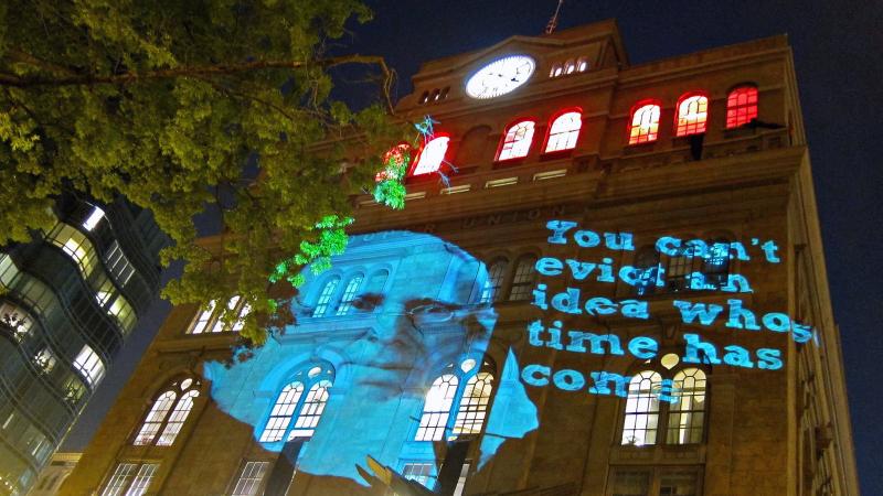 An image of Cooper Union founder Peter Cooper is projected on the office of school President Jamshed Bharucha, in protest of the institution's decision to begin charging tuition. An image of Cooper Union founder Peter Cooper is projected on the office of school President Jamshed Bharucha, in protest of the institution's decision to begin charging tuition.
