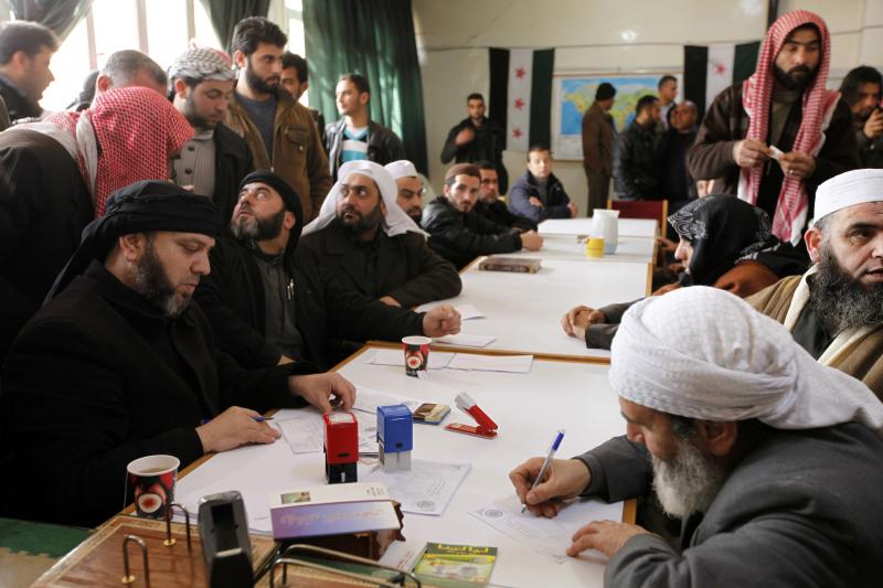 An Islamist rebel group in Aleppo called "the Authority for the Promotion of Virtue and Supporting the Oppressed" reviews applications for aid on Feb. 25. In addition to handing out aid, the Islamist group says it is carrying out civilian administration i An Islamist rebel group in Aleppo called "the Authority for the Promotion of Virtue and Supporting the Oppressed" reviews applications for aid on Feb. 25. In addition to handing out aid, the Islamist group says it is carrying out civilian administration i