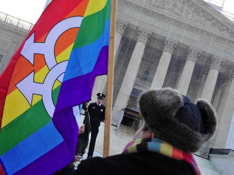 A pro-gay-marriage protester stands in front of the Supreme Court on Tuesday, the first of two days of oral arguments on challenges to laws that limit the definition of marriage to unions of a man and a woman. A pro-gay-marriage protester stands in front of the Supreme Court on Tuesday, the first of two days of oral arguments on challenges to laws that limit the definition of marriage to unions of a man and a woman.