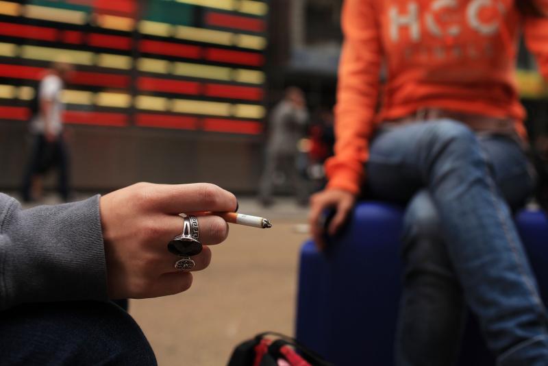 Women smoke in New York City's Times Square. Women smoke in New York City's Times Square.