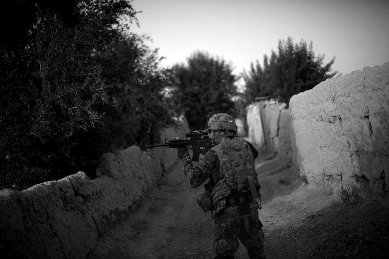 A soldier from the 4th Battalion, 9th Infantry Regiment, Manchus, looks toward the tree line through his rifle scope while on a foot patrol to visit Afghan Local Police in the Panjwai District of Kandahar province in southern Afghanistan. Panjwai is one o A soldier from the 4th Battalion, 9th Infantry Regiment, Manchus, looks toward the tree line through his rifle scope while on a foot patrol to visit Afghan Local Police in the Panjwai District of Kandahar province in southern Afghanistan. Panjwai is one o