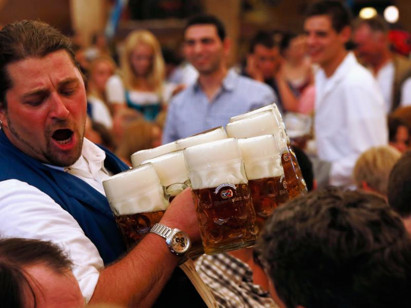 A waiter carries beer mugs during the 2012 Oktoberfest in Munich. A waiter carries beer mugs during the 2012 Oktoberfest in Munich.